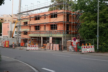 Construction site is visible on the side of a street