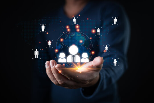 person presents a glowing digital network of global icons symbolizing customer and relationship management, showcasing interconnected user profiles and data sharing in a virtual business environment.