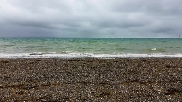 Aerial Drone Shot of Atlantic Ocean with Turquoise Waves and Cloudy Sky - Rightward Lateral Movement 