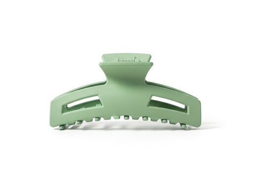 A pastel green matte hair claw clip isolated on white