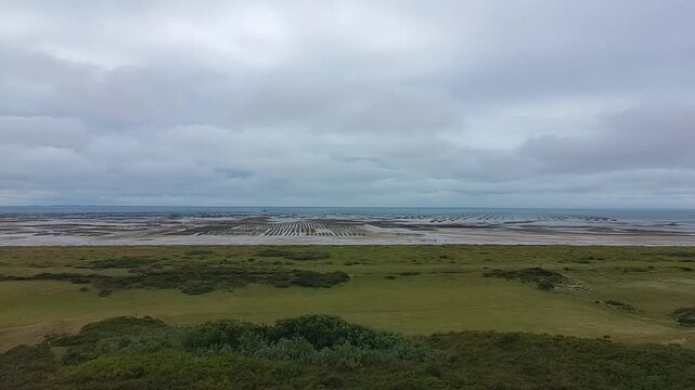 Long Forward Aerial Drone Shot Over Oyster Farms at Low Tide - Cloudy Sky 