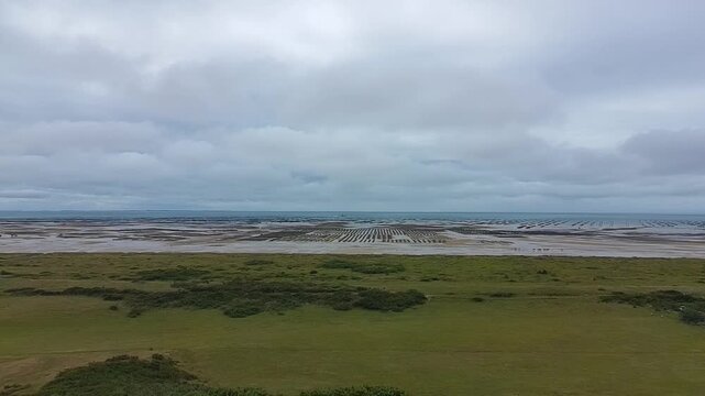 Aerial Drone Shot of Oyster Farms at Low Tide - Backward Reveal 