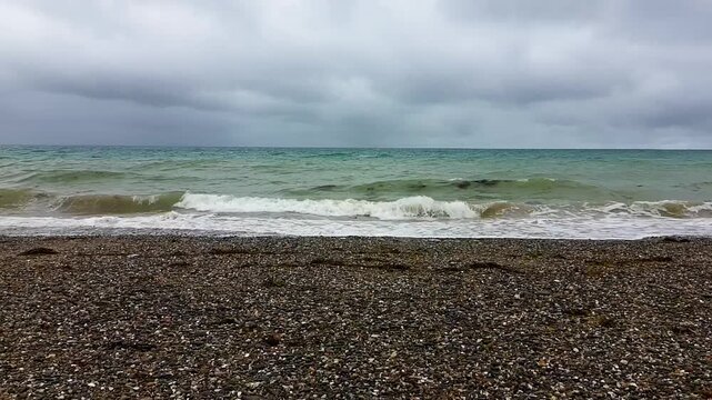 Aerial Drone Shot of Atlantic Ocean with Turquoise Waves and Cloudy Sky - Backward Movement 