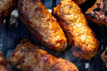 Pork chops, steak, sausages on barbecue grill