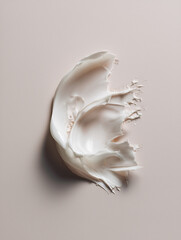 White smear of skincare cream on a soft gray background. Clean beauty product texture in macro style