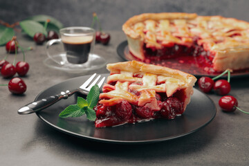Piece of tasty cherry pie and berries on grey table, closeup