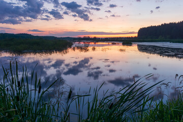 sunrise over the lake with reflections clouds in the water