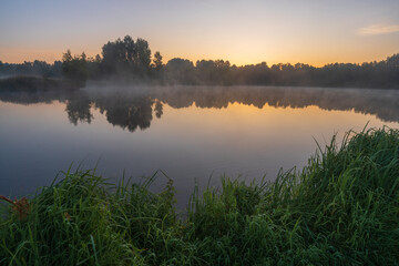 Fototapeta premium misty sunrise over the lake