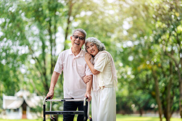 Smiling senior man and woman outdoor green park supportive loving relationship healthy aging lifestyle care
