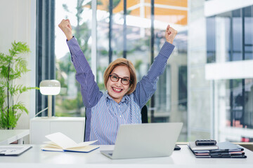 Successful Business Woman Celebrating Achievement at Desk with Laptop Asian Adult Achieving Goals Career Job Hiring Promotion Online Work Happy