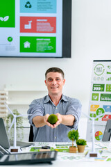 Adult man holding moss ball symbolizing global environmental sustainability and green business initiatives for carbon reduction achieving net zero future