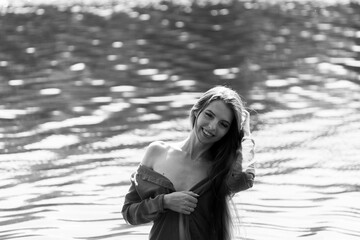 Elegant woman in red dress by the lake