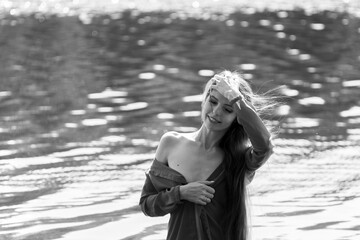 Elegant woman in red dress by the lake