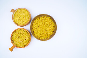 Various types of raw pasta in different containers in an isolated shot, with copy space on a white...