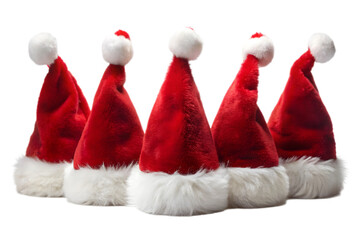Five red santa hats with white trim and pom poms arranged in a group isolated on white isolated on transparent background