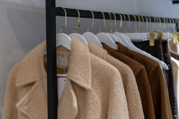 Fashion display featuring stylish coats in a retail clothing store