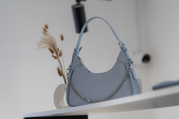 Stylish blue handbag displayed in modern retail store interior