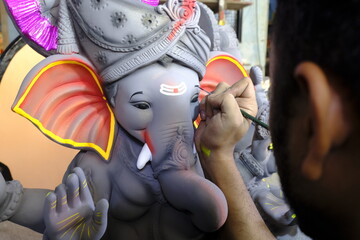 Artist paints an Idol of Lord "Ganesha", ahead of "Ganesha Chaturthi" festival in India.