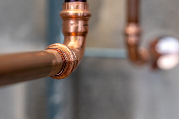 Press-fit fittings, copper pipe plumbing connections and fittings for new potable water pipes in a bathroom.