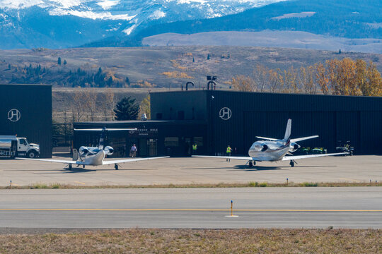 Jackson Hole Airport, Jackson, Wyoming, USA - October 5, 2023 - Netjets Cessna Citation Latitude and an smaller Cessna private jets waiting for passengers at the General Aviation area of JAC 