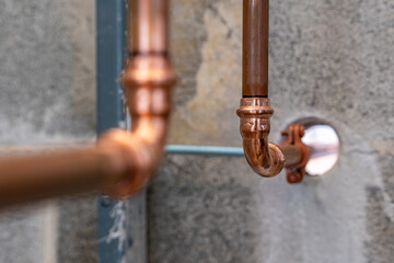 Press-fit fittings, copper pipe plumbing connections and fittings for new potable water pipes in a bathroom.