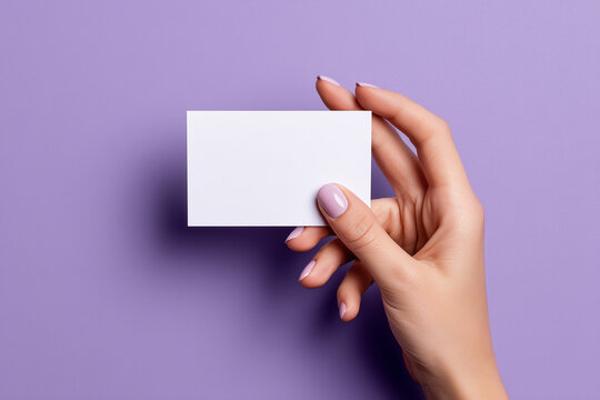 Blank business card mockup held in hand against purple background. Great for showcasing logos, personal branding or print-ready layouts.

