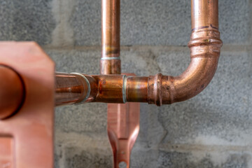 Combination soldered and press-fit fittings, copper pipe plumbing connections and fittings for new potable water pipes in a bathroom.