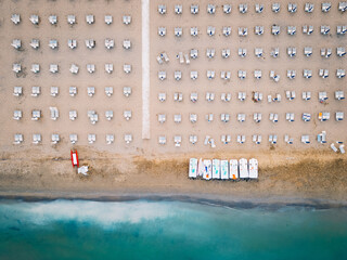 Aerial View of Symmetrical Beach Chairs and Pedal Boats on Shoreline in Lignano, Italy