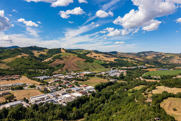 Panoramic aerial drone view of the Mercatale industrial and manufacturing area, near Sassocorvaro and the dam of the same name. We are in the province of Pesaro Urbino, Marche, Italy.
