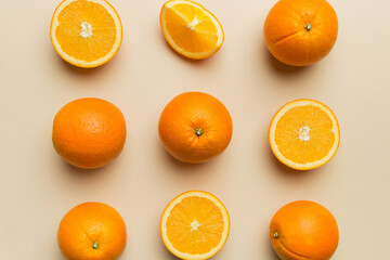 Fruit pattern of fresh orange slices on colored background. Top view. Copy Space. creative summer concept. Half of citrus in minimal flat lay