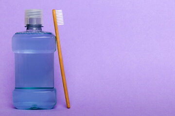 Mouthwash and other oral hygiene products on colored table top view with copy space. Flat lay. Dental hygiene. Oral care products and space for text on light background. concept