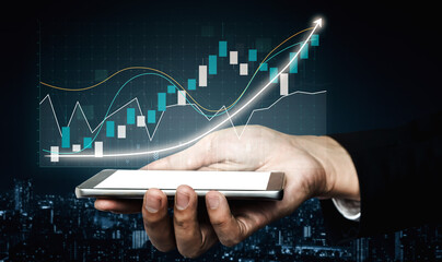 A close-up view of a hand holding a smartphone displaying financial graphs and charts, symbolizing growth and success in urban landscapes. Impute
