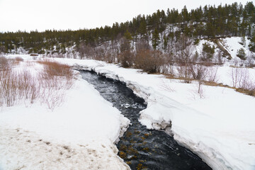 Meltwater stream cutting through snow in Dovrefjell, Norway