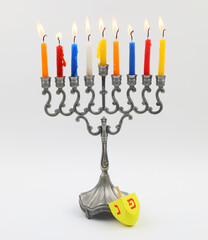 Hanukkah Menora and dreidel, isolated over white background