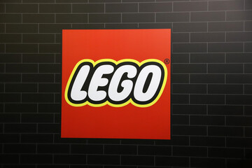 Obraz premium Isolated logo of the Lego toy block brand on a black brick background