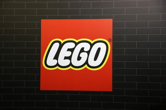 
Isolated logo of the Lego toy block brand on a black brick background