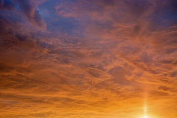 Golden sunrise sky with dramatic clouds