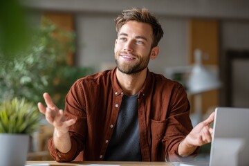 Confident young male employee engaging in discussion at a modern office workspace during daylight hours