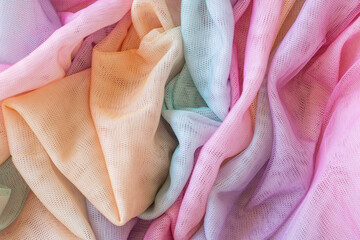 Colorful tulle fabric with a rainbow pattern. The colors are bright and vibrant, creating a cheerful and lively mood