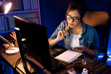 Thinking young beautiful Asian creative woman focusing on smartphone of sales target report...