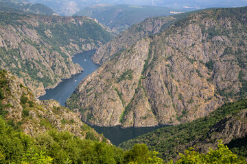 Fototapeta premium Scenic viewpoint Cabezoás overlooking the Sil Canyon, Ribeira Sacra, Ourense, Galicia. Stunning river gorge, lush landscapes, and dramatic cliffs in northwest Spain.