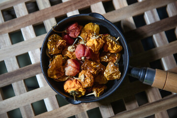 Dried chili peppers in a black iron pot