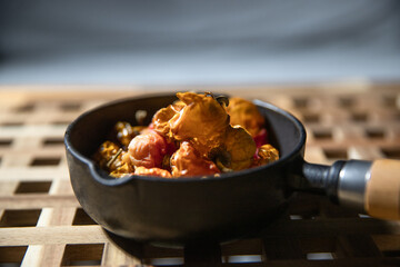 Dried chili peppers in a black iron pot