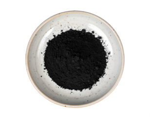 Fine charcoal powder in a rustic ceramic bowl, perfect for detox and beauty ingredient concepts