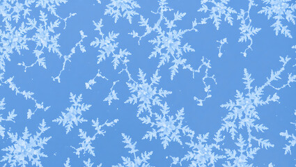 A repeating pattern of white snowflakes against a light blue background winter holiday design