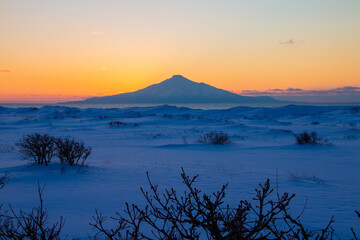 Mount Rishiri in winter with the sunset in the background
