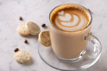 Cafe latte on marble surface – Top view - Creamy latte coffee on elegant marble table - Fresh latte drink with foam on marble texture