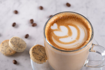 Cafe latte on marble surface – Top view - Creamy latte coffee on elegant marble table - Fresh latte drink with foam on marble texture