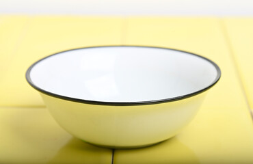 Beautiful photo of a Vintage Enamel Mock up Bowl on Yellow Tiled Surface