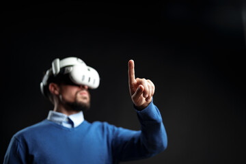 User engages in virtual reality experience while wearing VR headset indoors during a tech...